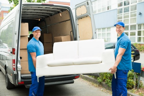 Removal team preparing furniture safely before loading