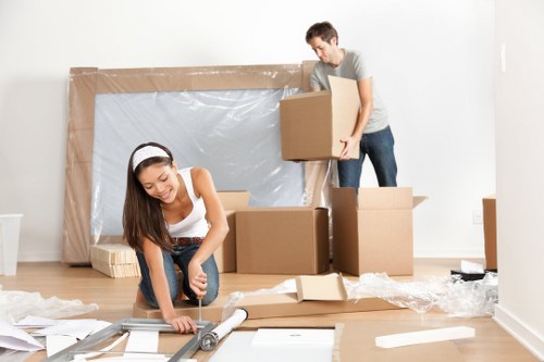 Mover carrying furniture through a Streatham apartment building