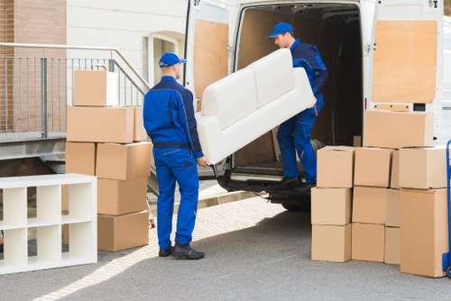 Staff assessing and moving items with care during a house move