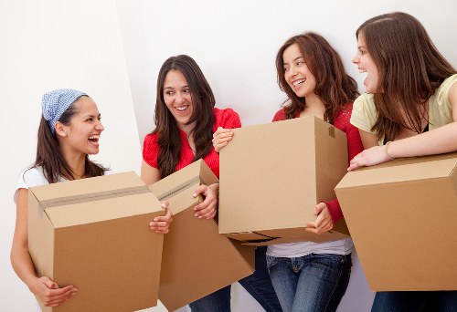 Removal specialists loading household items for transport in Streatham