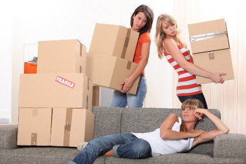 Professional movers loading furniture into a moving truck